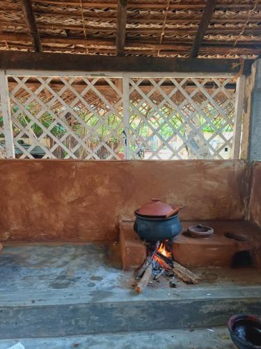 a pot over a fire in a room at Malabar home stay in Jaffna