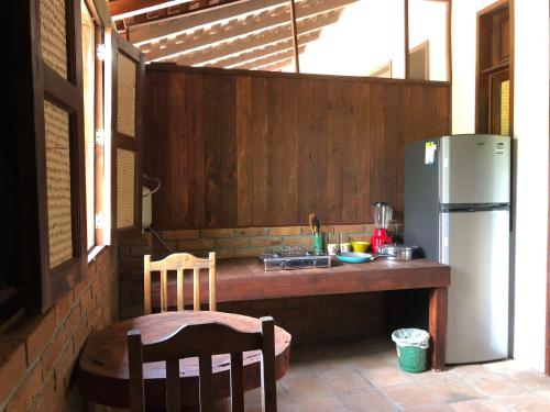 cocina con mesa y nevera en Hab #9 La Casa Del Profe Salo en Santa María Tonameca