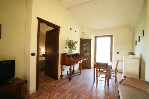 a living room with a piano and a table at Valle di Assisi Country Apartments in Assisi