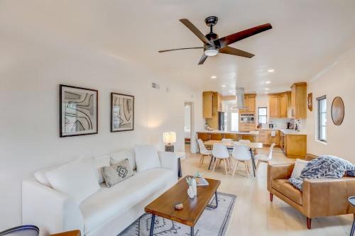 a living room with a white couch and a ceiling fan at Sam Hughes Desert Oasis, Private Pool & Walk to UA in Tucson