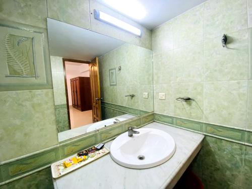 a bathroom with a sink and a mirror at Cozy private Ac Attached bath Room- Gulshan 1 in Dhaka