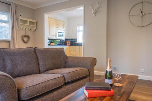 a living room with a couch and a table at Stone's Throw Away from the English Channel! -Family and Dog Friendly in Wootton