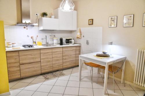 een keuken met een tafel en een wit aanrecht bij CASA LISANDER in Lecco