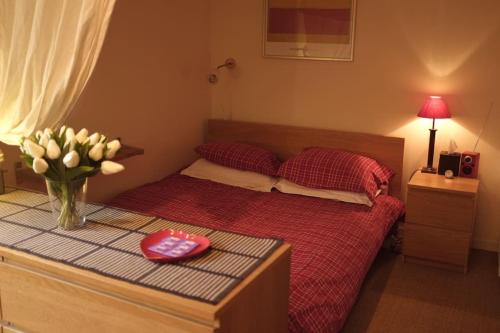 - une chambre avec un lit orné d'un vase de fleurs dans l'établissement Studio très calme Montparnasse, à Paris