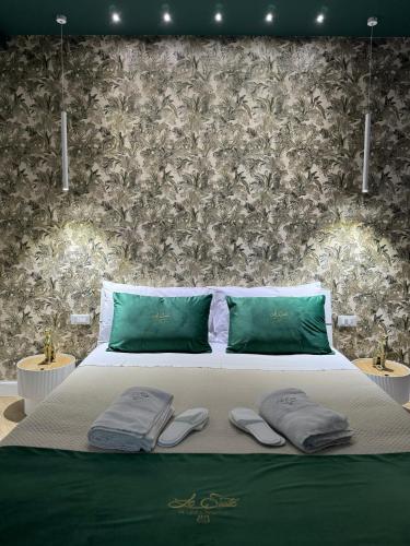 a bedroom with a bed with two towels on it at Le Suite Piazza Nuova in Foggia
