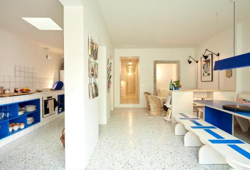 a kitchen with blue and white cabinets and a dining room at Casa Pavão in Lisbon
