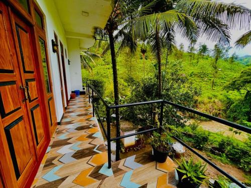 a room with a door and a balcony with plants at River view family rest in Demodera