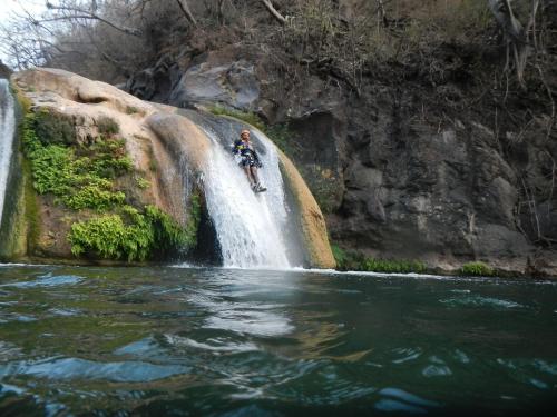a person riding a bike in front of a waterfall at Hotel La Casona in Tapalpa