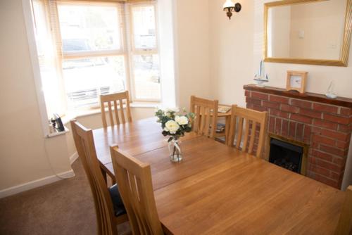 a dining room with a table and a fireplace at Breakfast With A View Free Parking and Water Access in Wallington