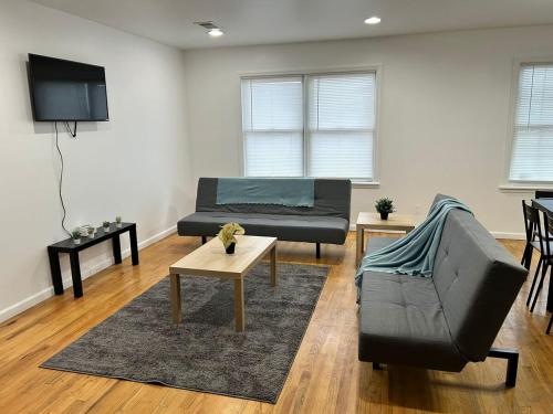 a living room with a couch and a table at Bright & Spacious 3-Bed Close to NYC in Jersey City