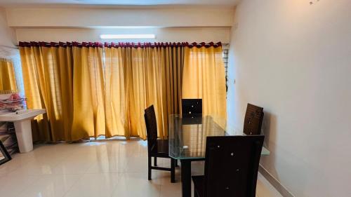 a dining room with a glass table and chairs at Entire place-4BHK Apartment Bashundhara R/A in Dhaka