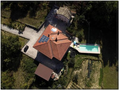 an overhead view of a house with a roof with a swimming pool at 3 bedrooms house with private pool terrace and wifi at Abbateggio in Abbateggio