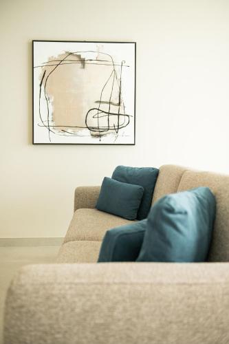 a couch in a living room with a painting on the wall at Amarilla Golf Residences in San Miguel de Abona