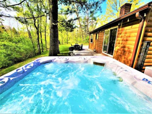 a hot tub in the backyard of a house at Creekside Hot Tub-Walk to Beach-Uniquely Northern in Traverse City