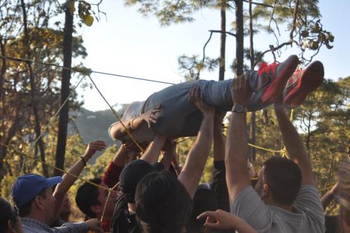 a group of people holding a man on a pole at Hotel La Casona in Tapalpa