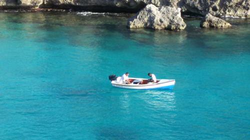 two people in a small boat in the water at Bon Bini Lagun Curacao in Lagun