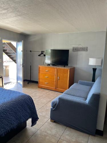 a bedroom with a bed and a flat screen tv at Budget Inn in Punta Gorda