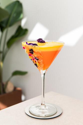 a drink in a martini glass on a table at Amarilla Golf Residences in San Miguel de Abona