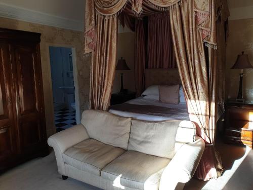 a living room with a bed and a couch at Mansion House Hotel in Elgin