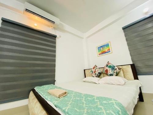 a bedroom with a bed and a window at Penthouse -Private Room with Attach bath Ac & Rooftop in Dhaka