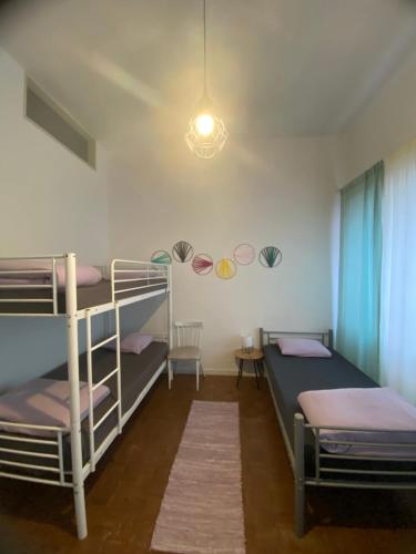 a room with two bunk beds and a light at Barão 35 Guest House in Braga