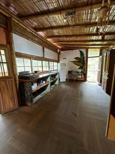 a large room with wooden flooring in a house at Cabaña Canto de las Aguas Cañón del Combeima in Ibagué
