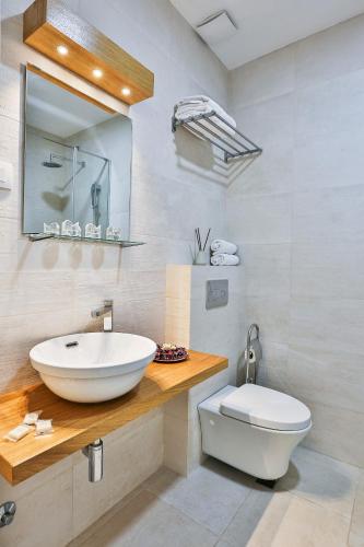 a bathroom with a sink and a toilet at Royal Gardens Paradise in Budva