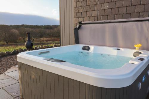 a jacuzzi tub with a bird in the background at Red Squirrel in Dornoch