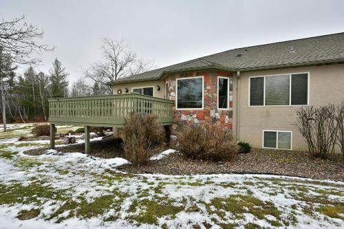 a house with a wooden deck in the snow at Unit 701 5 bd 3 ba condo in Birchwood
