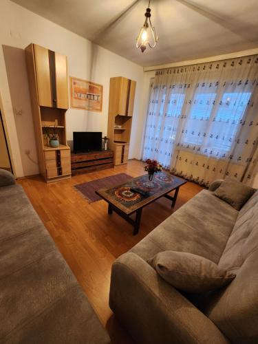 a living room with a couch and a table at City Park Apartments in Pristina