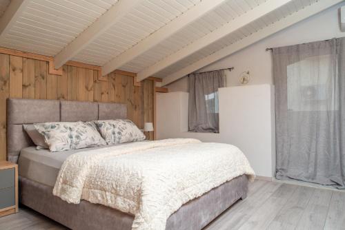 a bedroom with a bed and a wooden wall at Giannis House in Rhodes Town