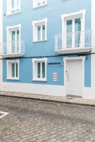 a blue and white building with a white door at Downtown PDL Premium in Ponta Delgada
