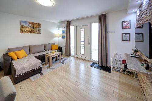 a living room with a couch and a table at Apartman Nena in Pirot