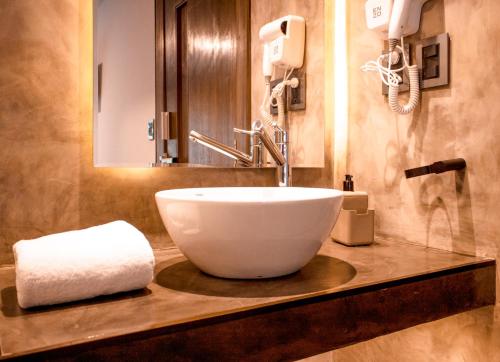 a bathroom with a large white bowl sink on a counter at Madero Hotel & Suites in La Paz