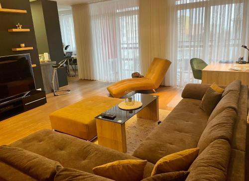 a living room with a couch and a tv at Resident Apartment in Košice