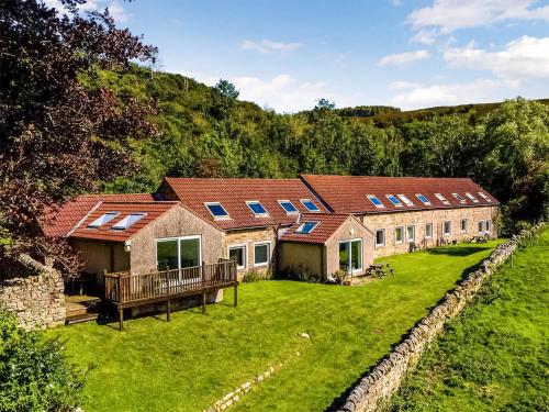 a row of houses with solar panels on them at Heather Cottage- Uk45889 in Farlam