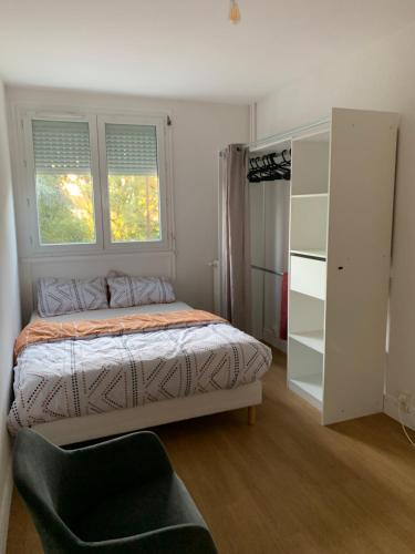 a bedroom with a bed and a window at Chambre à louer dans appartement in Brétigny-sur-Orge
