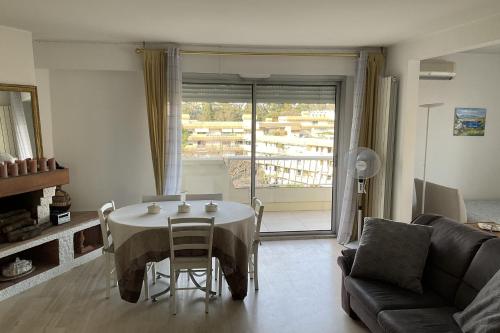 a living room with a table and a couch at top floor apartment with private park in Montpellier