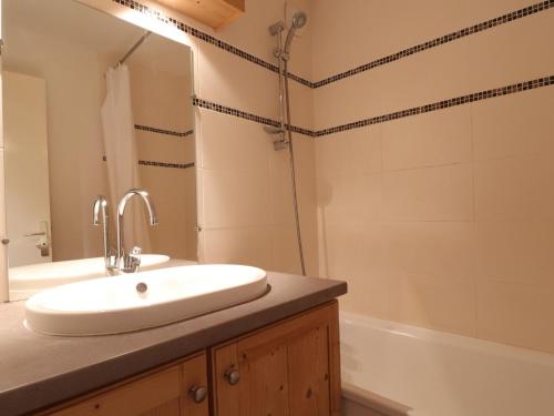 une salle de bain avec un lavabo et une baignoire dans l'établissement Appartement 2 Pièces, Ski aux Pieds, Proche Commerces, Wi-Fi Gratuit, Animaux Admis - FR-1-182-195, à Les Allues