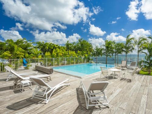 a patio with chairs and a swimming pool at B&B HOTEL Fort-de-France in Fort-de-France