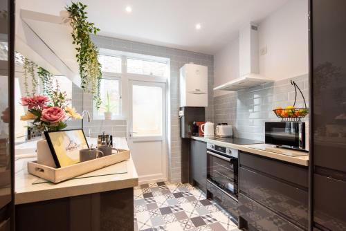 a kitchen with a sink and a counter top at A Stylish Gem with King Beds - WiFi & Parking in London