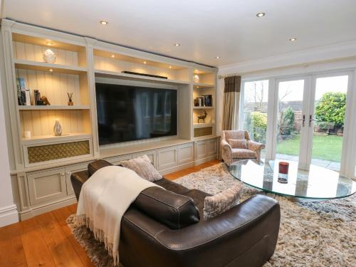 a living room with a couch and a tv at Moor View in Glossop
