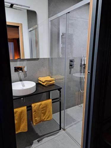 a bathroom with a glass shower and a sink at Le 7 in Vieille-Toulouse