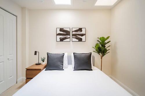 a bedroom with a large white bed with two pillows at Lively 3BR Apt in Chicago - Milwaukee N3 in Chicago