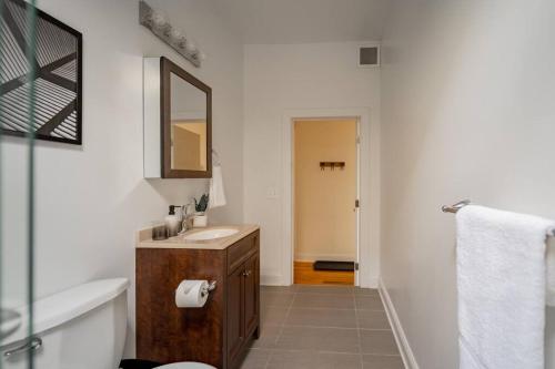a bathroom with a sink and a mirror at Lively 3BR Apt in Chicago - Milwaukee N3 in Chicago