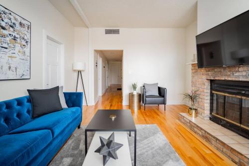 a living room with a blue couch and a fireplace at Lively 3BR Apt in Chicago - Milwaukee N3 in Chicago