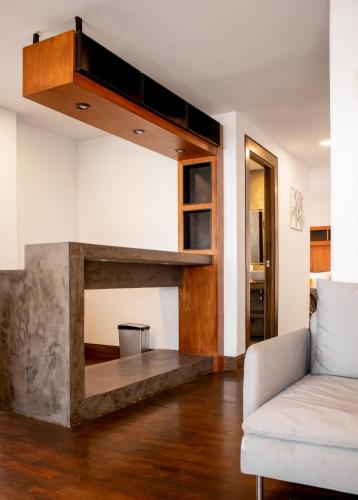 a living room with a couch and a fireplace at Madero Hotel & Suites in La Paz