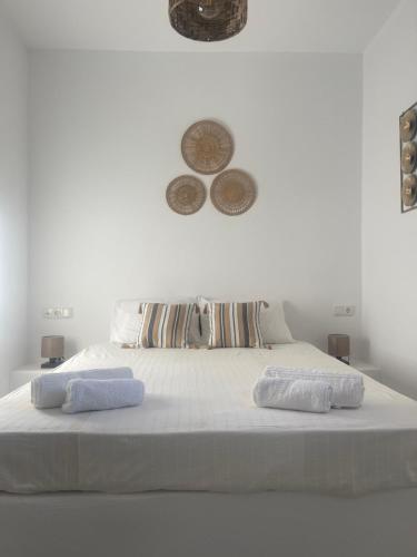 a white bed with two towels on top of it at Nektarios apartment in Mikri Vigla