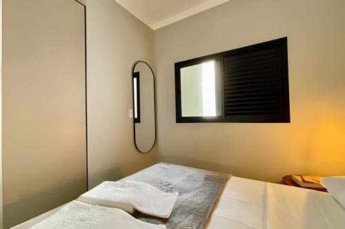 a bedroom with a bed with a mirror and a window at MY STUDIO in Franca