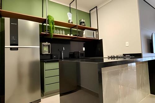 a kitchen with a black counter and green walls at MY STUDIO in Franca